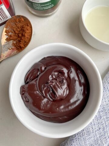 chocolate glaze for brownies in a white bowl. 