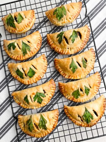 baked vegetarian empanadas on a wire baking rack