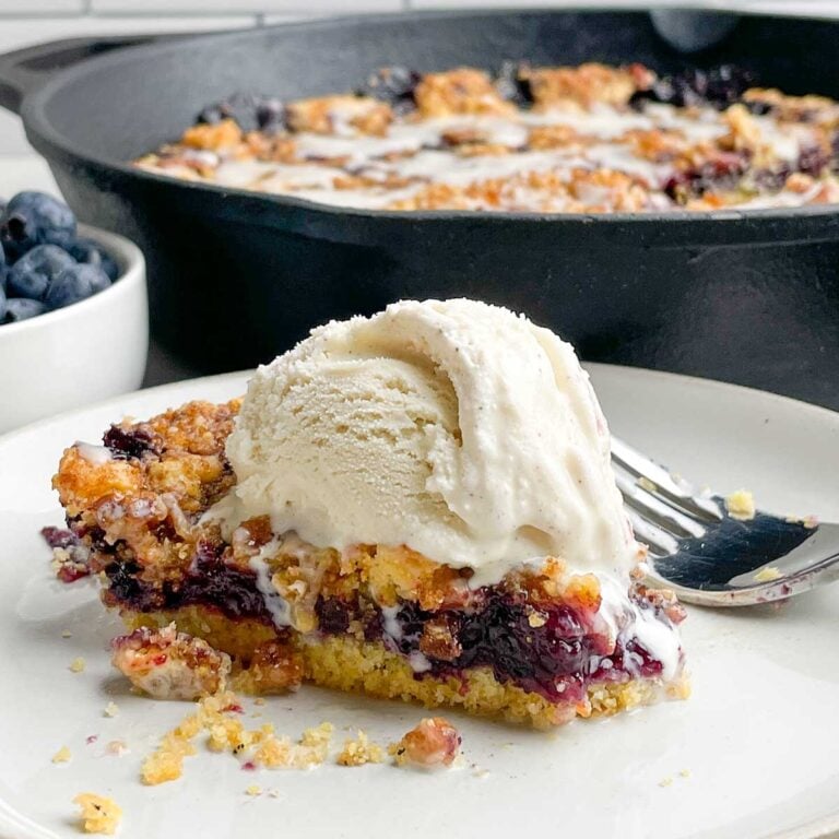 slice of Cornbread Blueberry Buckle Coffee Cake with ice cream on top