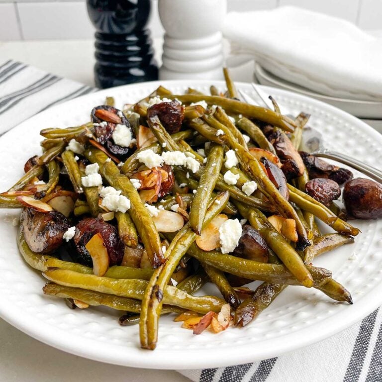 roasted green beans and mushrooms on a white plate