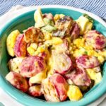 radish potato salad in a blue bowl.