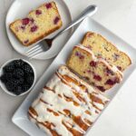 loaf of lemon blackberry bread on a white platter