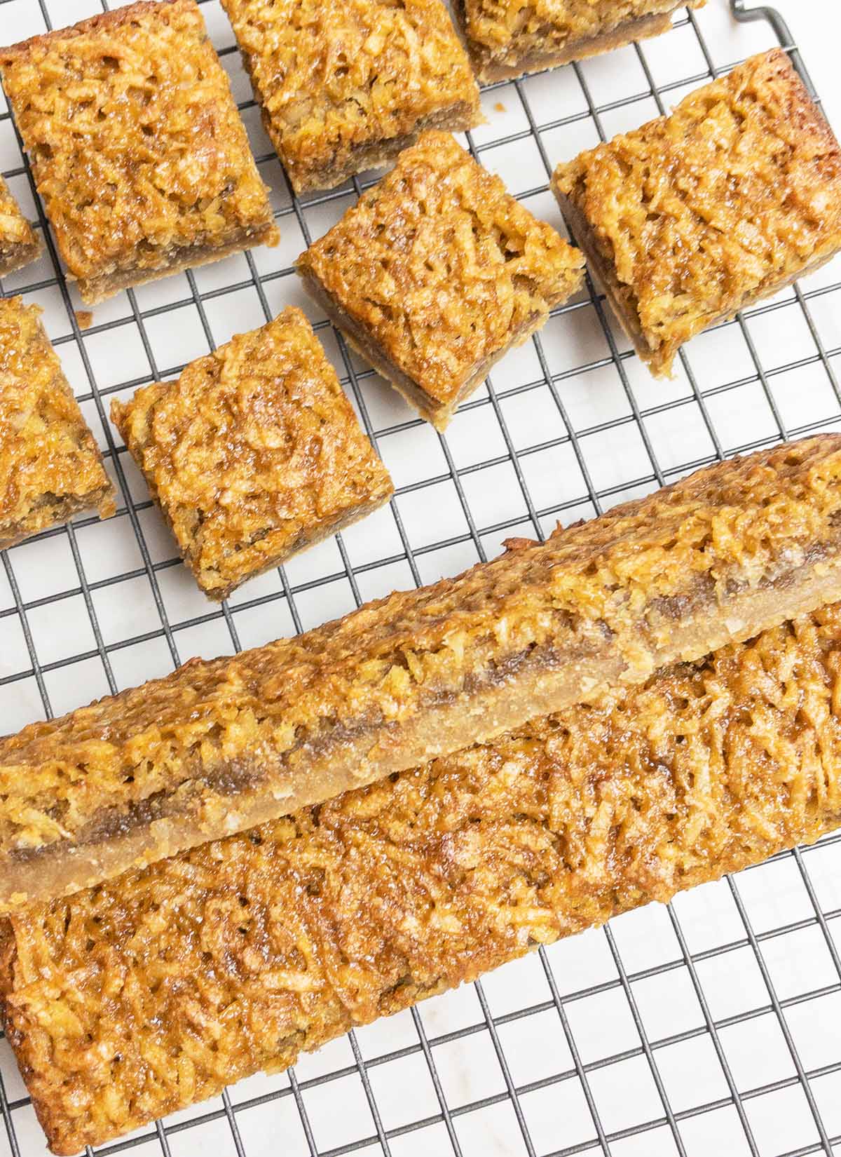 coconut dream bars on a wire baking rack.
