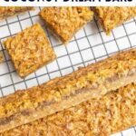 coconut dream bars on a wire baking rack.