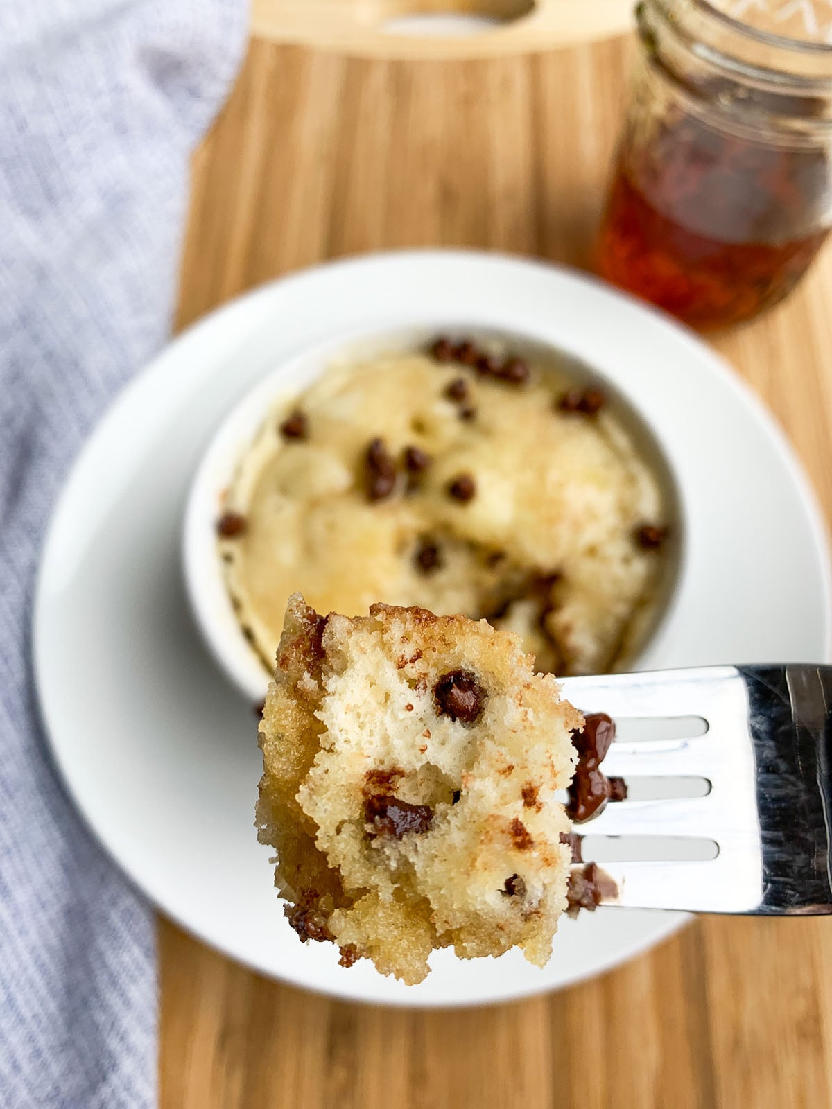chocolate chip pancake in a mug with maple syrup.