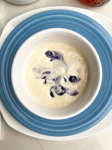 blueberry pancake batter in a mug.