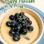 blueberry pancake in a mug topped with blueberries.