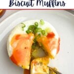 sausage egg and biscuit muffin on a plate with hot sauce.