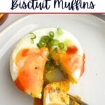 sausage egg and biscuit muffin on a plate with hot sauce.