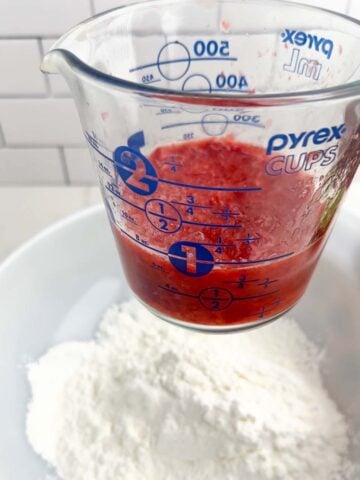 mashed strawberries in a pyrex cup.