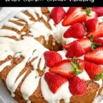 strawberry angel food cake topped with cream cheese glaze and fresh strawberries.