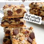 hello dolly bars cut into squares stacked on a white countertop.