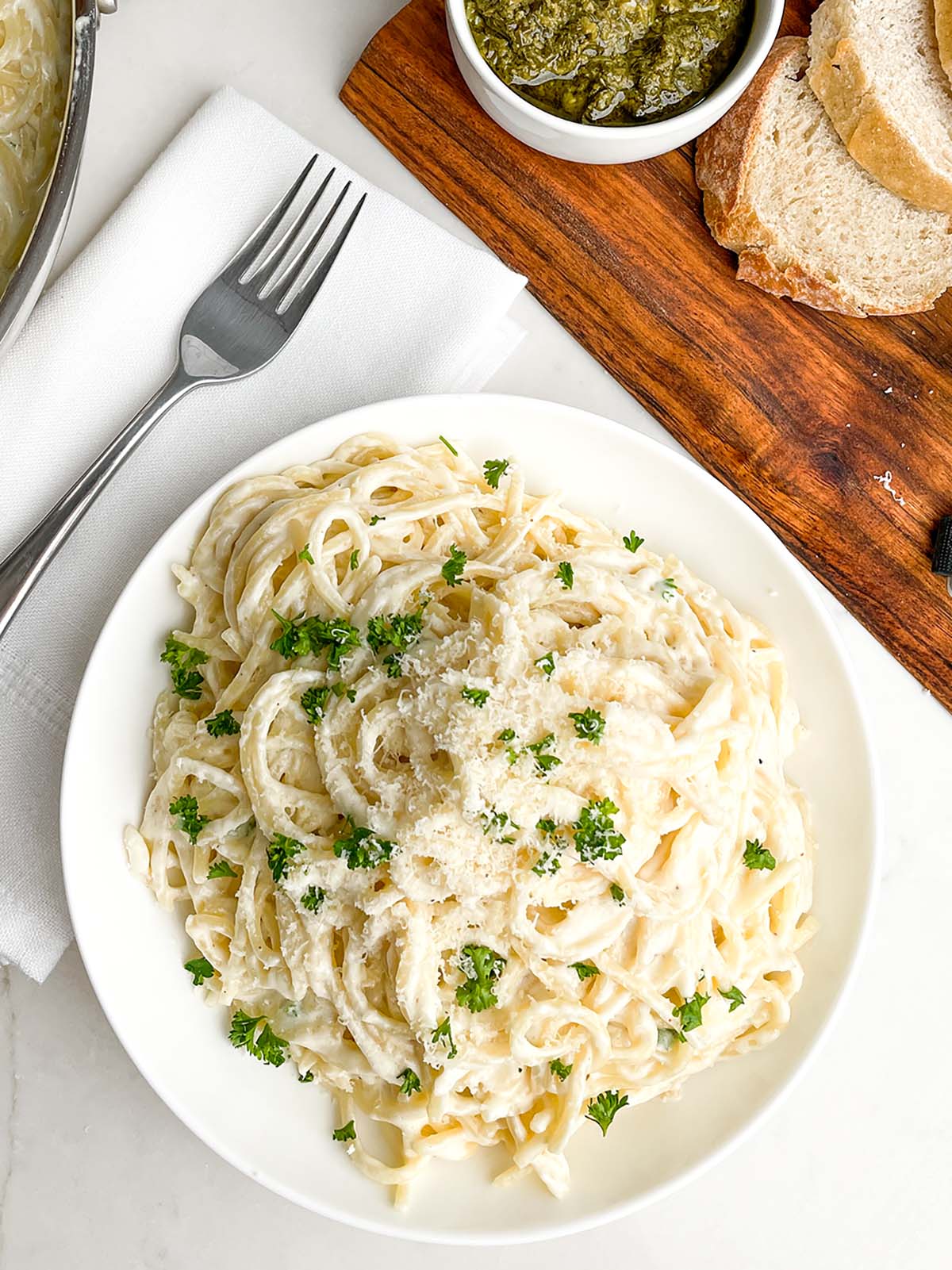 a plate of spaghetti with Alfredo. sauce.