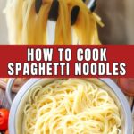 a colander of cooked spaghetti on a red and white checkered tablecloth.