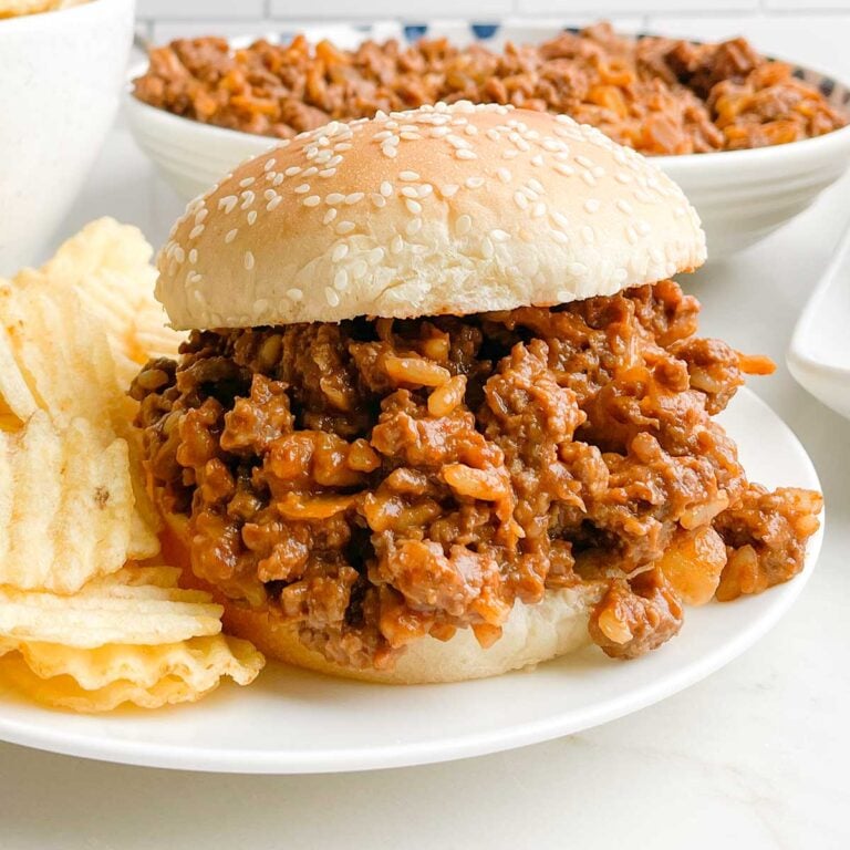 chicken gumbo sloppy joe on a white plate with potato chips