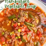 ground beef vegetable soup in a white bowl.