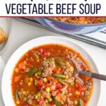hamburger vegetable soup in a white bowl.