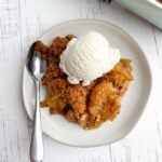 serving of apple crisp without oatmeal with ice cream on a white plate