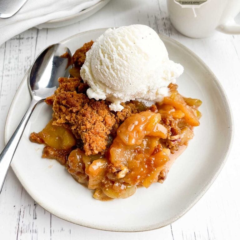 serving of apple crisp without oatmeal with ice cream on a white plate