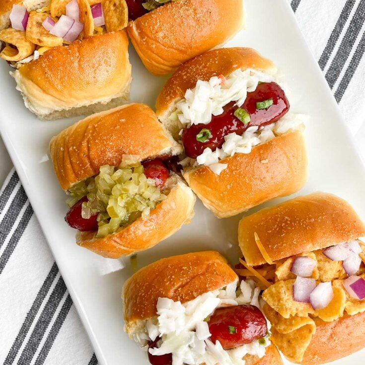 mini hot dog appetizers on a white platter
