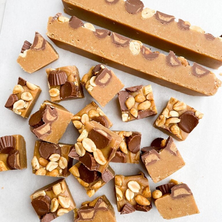 squares of no bake peanut butter fudge on parchment paper