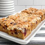 pumpkin yellow cake mix magic bars on white platter