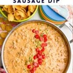 Sausage Rotel dip in a skillet next to Fritos and plates.