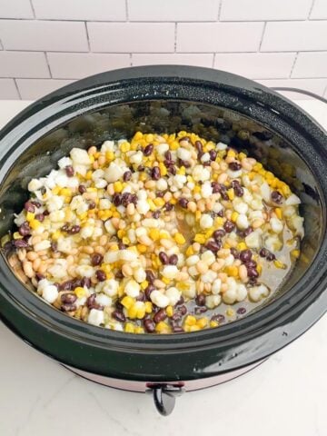 cream cheese chicken chili mixture in black slow cooker