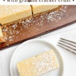 lemon bars on a wood cutting board.