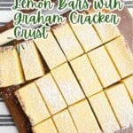 lemon bars on a wood cutting board.