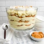 easy banana pudding in a trifle dish on a blue and white napkin