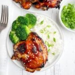 air fryer teriyaki chicken thigh on a white plate with white rice and broccoli