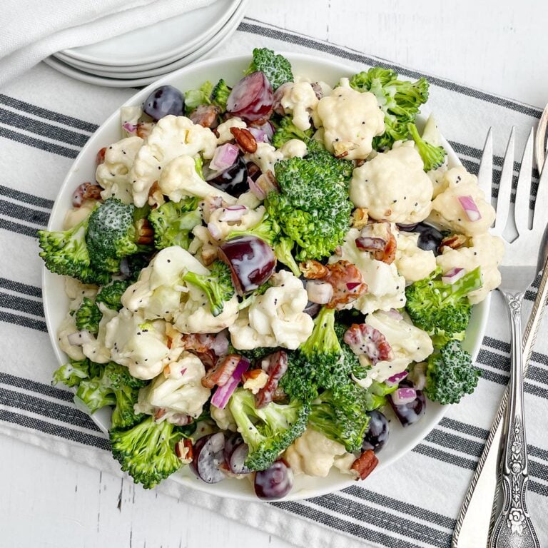 Broccoli cauliflower bacon salad in a white bowl