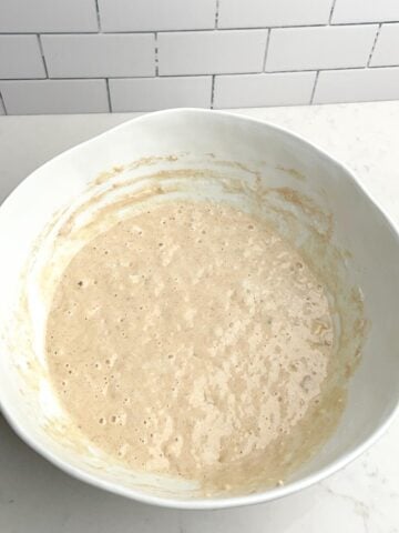 banana pancake batter in white mixing bowl