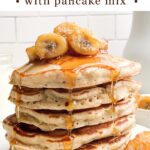 a stack of banana pancakes with caramelized banana topping on a white plate.