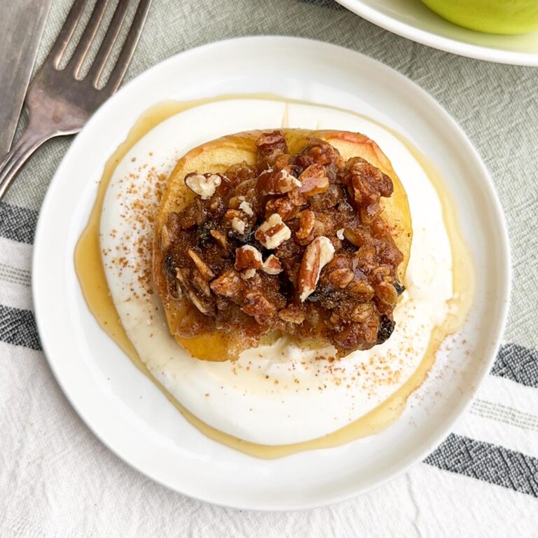 healthy baked apple with yogurt on a white plate