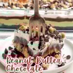 fork piercing through a piece of peanut butter oreo heavenly dessert on a white plate.