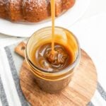 caramel sauce being drizzled into a mason jar
