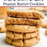 a stack of brown butter peanut butter cookies on parchment paper.