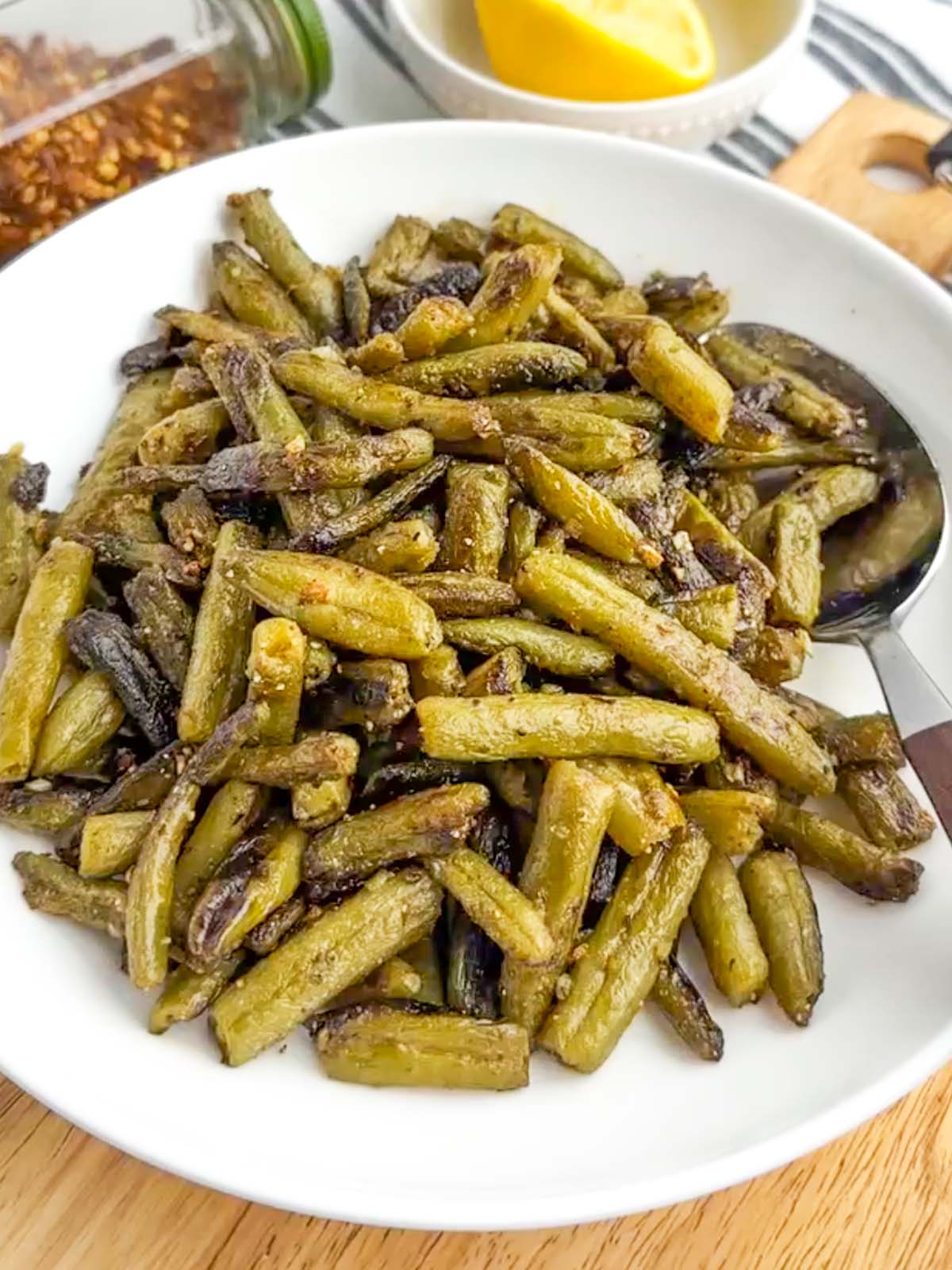 sauteed canned green beans in a white bowl.