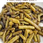 sauteed canned green beans in a white bowl.