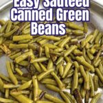 sauteed canned green beans in a stainless steel skillet.