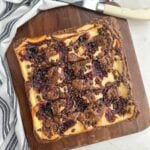 blueberry cheesecake brownies on a cutting board.