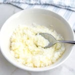 spoon in a white bowl of lemon sugar.