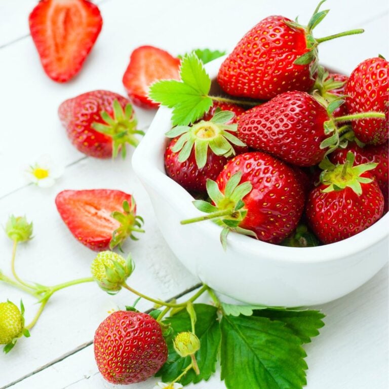 fresh strawberries in a white bowl.