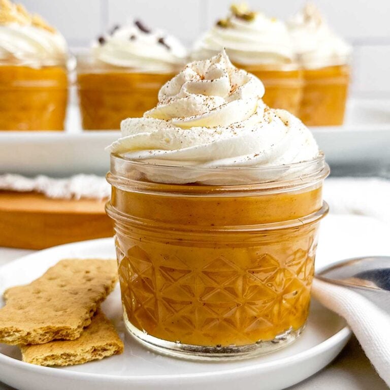 pumpkin pudding in a mason jar topped with whipped cream.