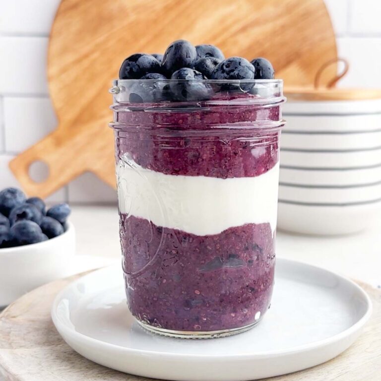 berry chia seed pudding layered with yogurt in a mason jar.