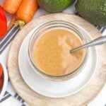 bbq ranch dressing in a mason jar surrounded by fresh vegetables.