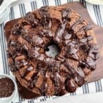 chocolate angel food cake with chocolate ganache on a white plate.