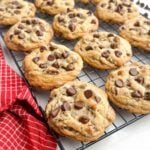 bakery style chocolate chip cookies on a wire baking rack.